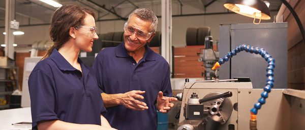 man and woman talking in workplace